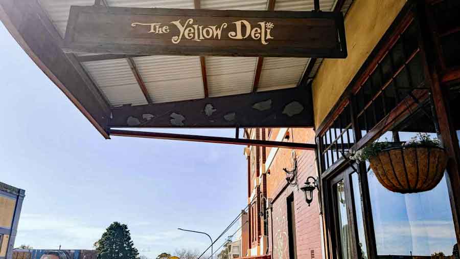Hidden-Creek-Tiny-Home-The-Yellow-Deli Image of yellow Deli sign